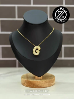 Inicial Oro laminado - globito con circo...